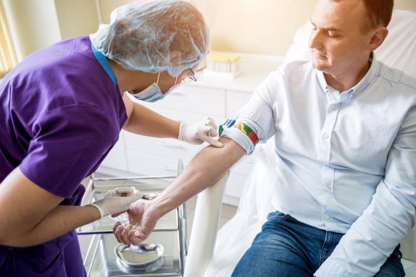 Volunteer donating blood during a community health drive